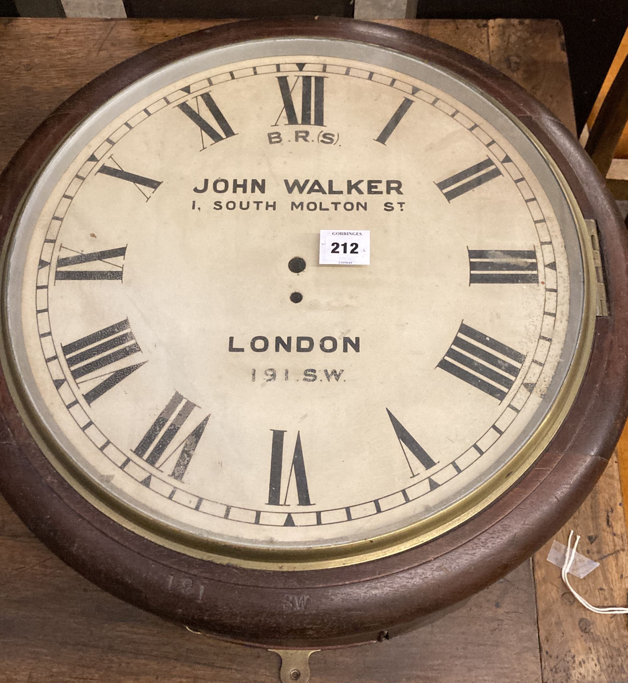 A large British Rail mahogany wall clock case, lacking movement, stamped 191SW, Diameter 57cm.